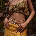 Gold belly chain showcasing ceramic floral and shell charms.