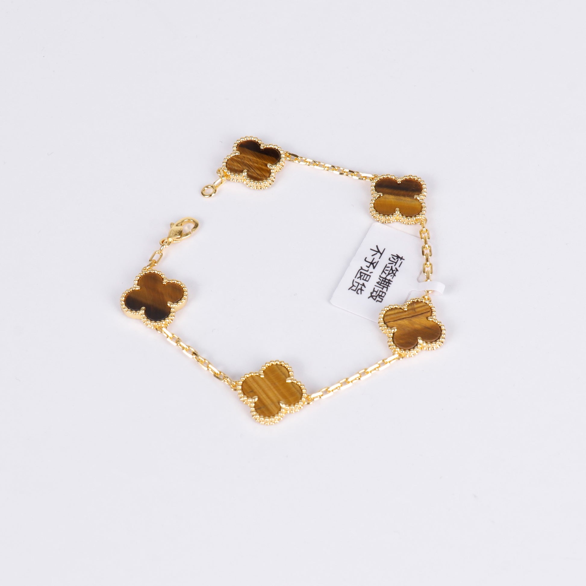 Spiritual gold bracelet with tiger eye clover symbol for women