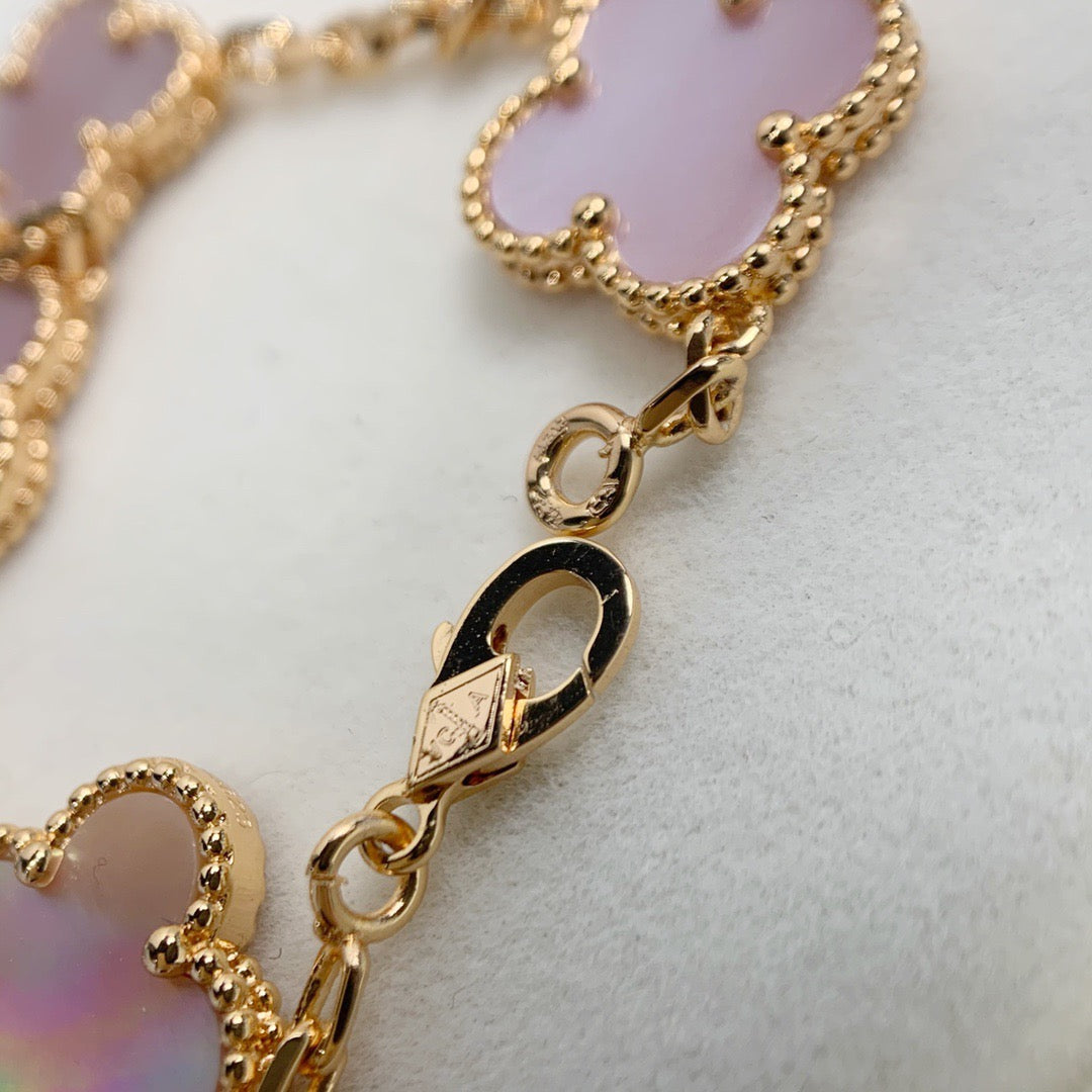 Pink aesthetic bracelet with lucky clover symbol in gold