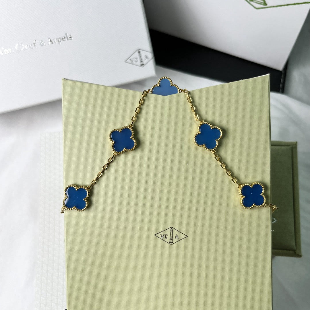 Romantic charm bracelet with four-leaf blue clover