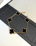 Bold black enamel bracelet with lucky clover charm