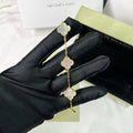 White clover charm bracelet in 18K gold with glossy enamel finish