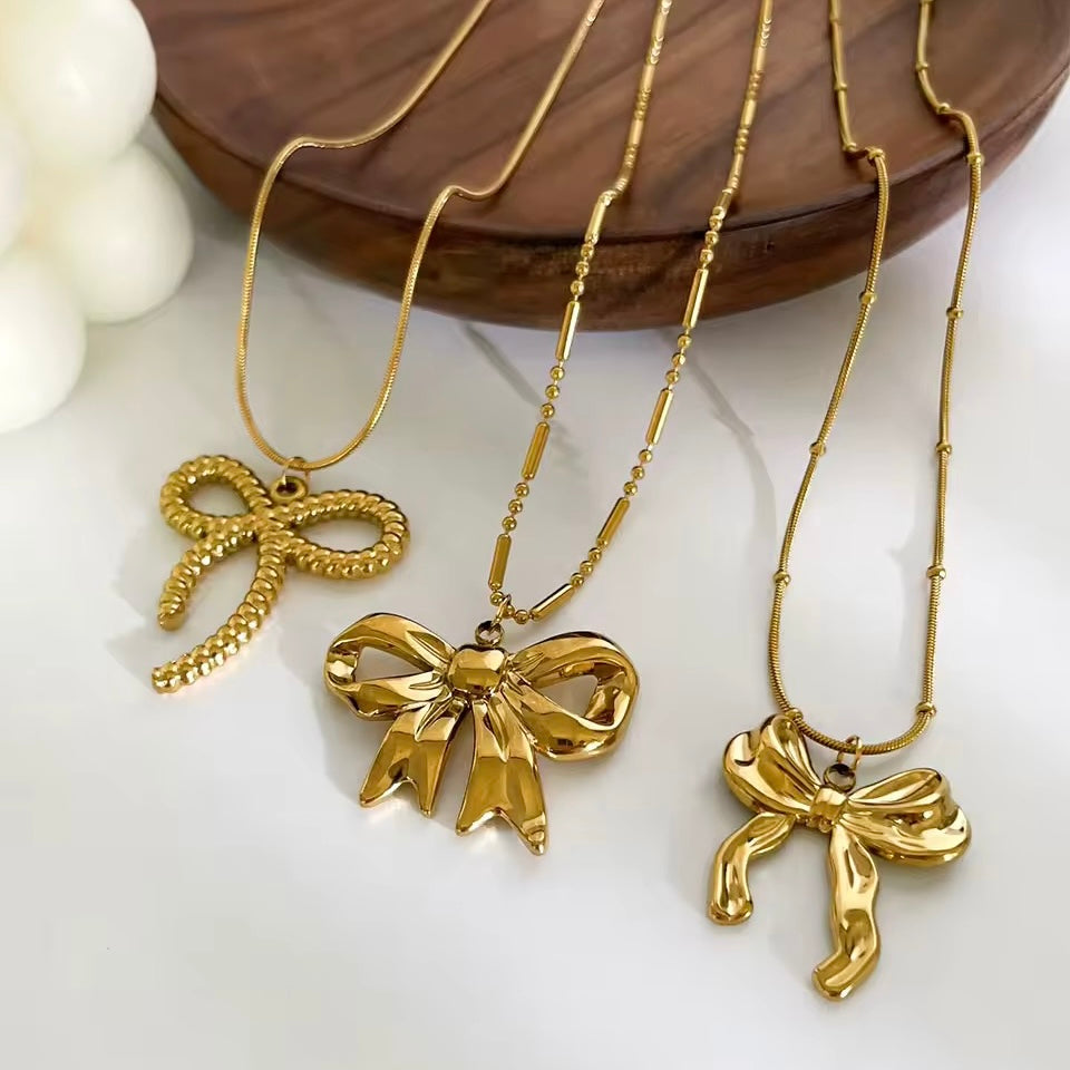 Gold coquette bow pendant necklace with delicate thin chain