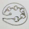 Gold waist chain belt with moon, sun, and star charms styled over a black dress