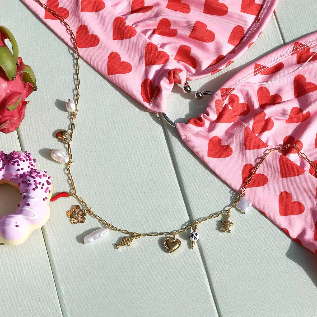 Bohemian-style waist chain with detailed gold link design and multi-charms.