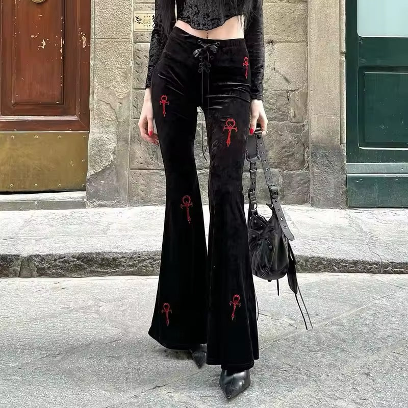 Gothic cross flared pants, dark velvet high-waisted trousers with embroidery, Y2K streetwear aesthetic for Mall Goth, punk grunge, and Harajuku fashion