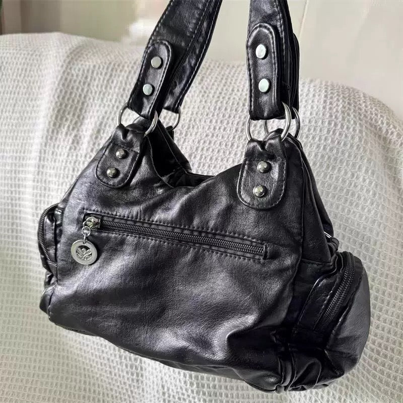 Black leather shoulder bag with butterfly accent