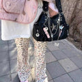 Close-up of silver star and padlock details on spicy girl crossbody bag