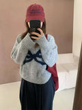 Light gray sweater styled in cozy interior