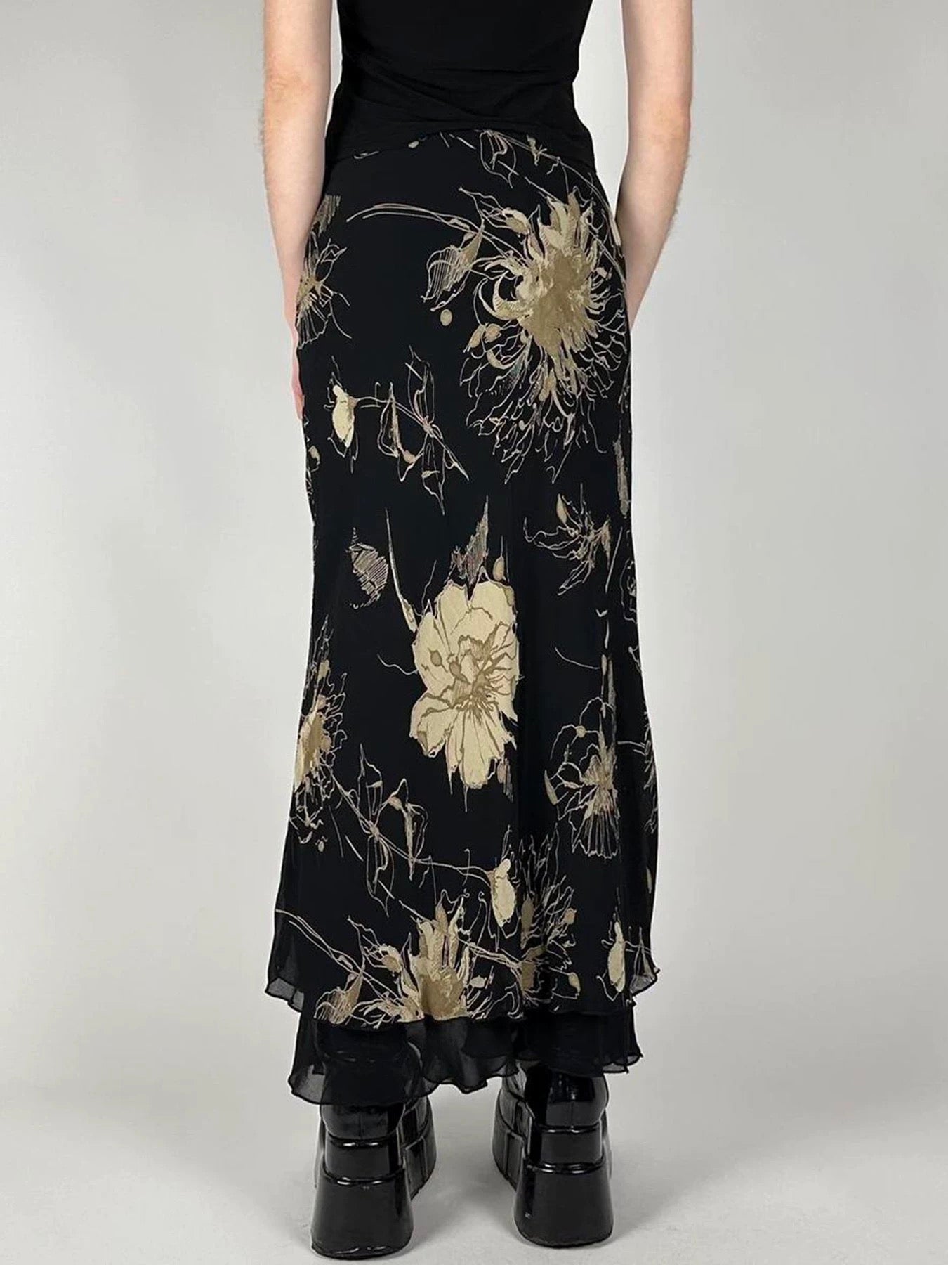 Side angle displaying the skirt's elegant drape and mid-waisted fit.
