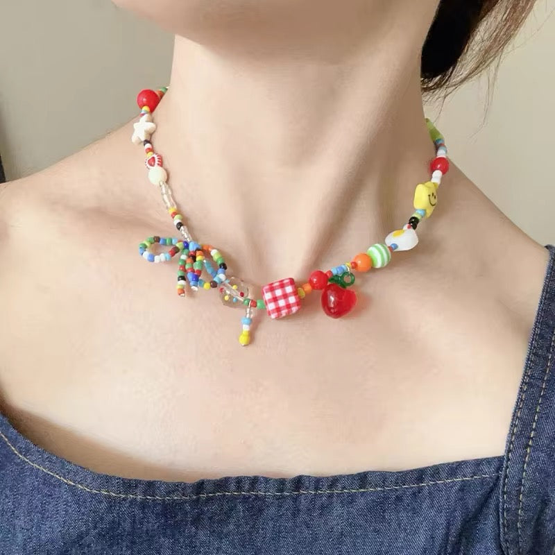Cartoon-inspired fruit charm necklace with tassel pendants and pastel bows, Harajuku aesthetic choker for Kpop and vintage Y2K outfits