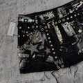 Washed black denim skirt with low waist fit, star embroidery and punk elements