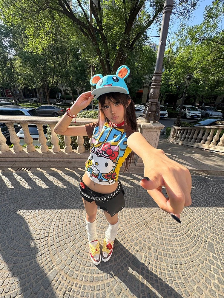 Full-body shot styling the kawaii t-shirt with mini shorts, chunky sneakers, and bright cap.