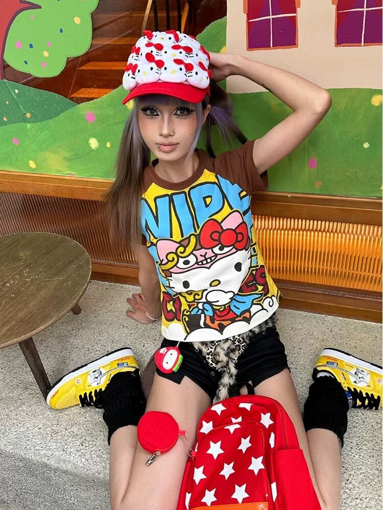 Kawaii Hello-Kitty inspired graphic tee with brown raglan sleeves and bold yellow comic print