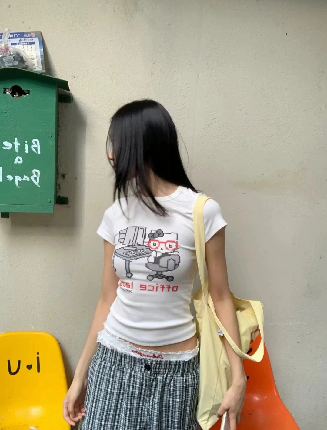 Side profile showcasing the short sleeves and tailored fit of the Sanrio tee