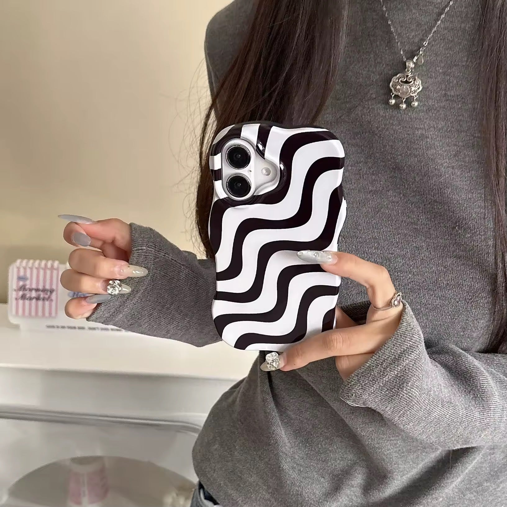 Close-up of the black and pink stripes merging in a wave design on the iPhone case.