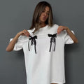Loose-fit cotton tee with bow element design, Y2K vintage streetwear inspired, perfect for relaxed styling and Korean fashion lovers