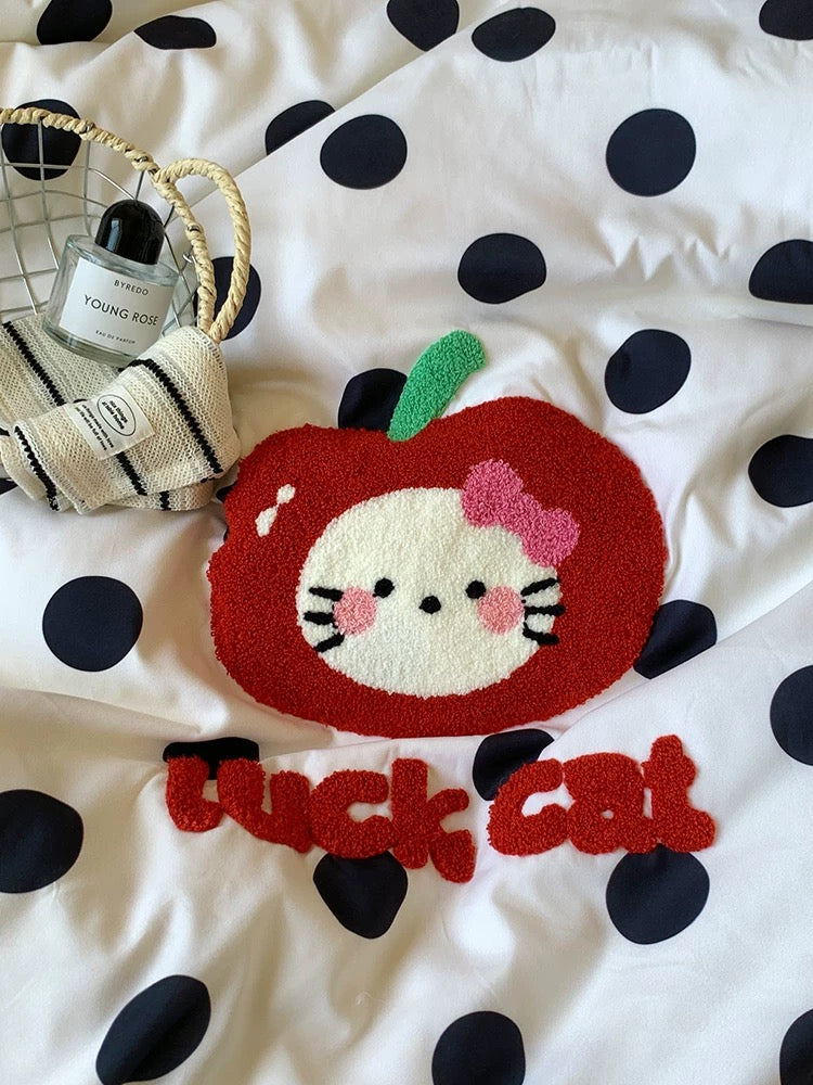 Cushion with a cartoon cat design and 'lucky cat' text on a polka dot background