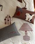 Decorative pillows with cartoon cat design on a white background