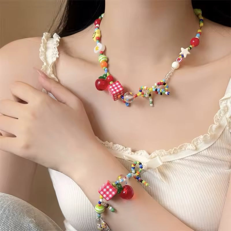 Y2K egirl necklace with cartoon fruit, star, and bow charms, colorful beaded choker for kawaii dopamine jewelry fashion looks