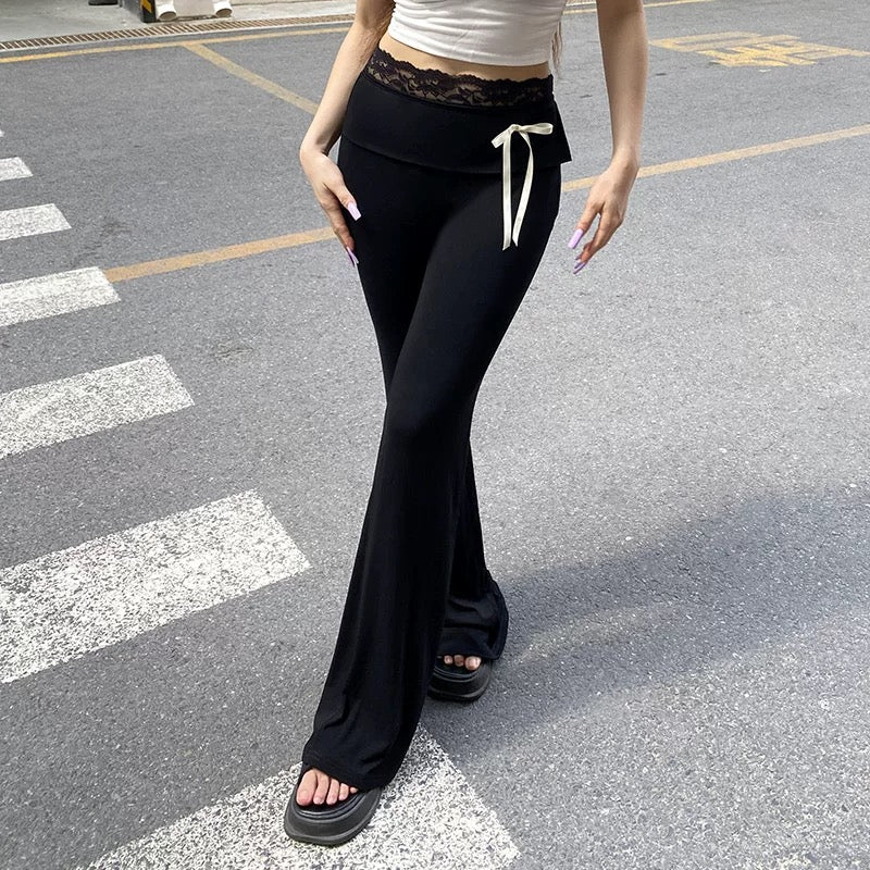 Soft girl coquette aesthetic lace-trimmed flare pants, low-waisted black leggings with bow accents, perfect for Y2K, Harajuku, and streetwear fashion