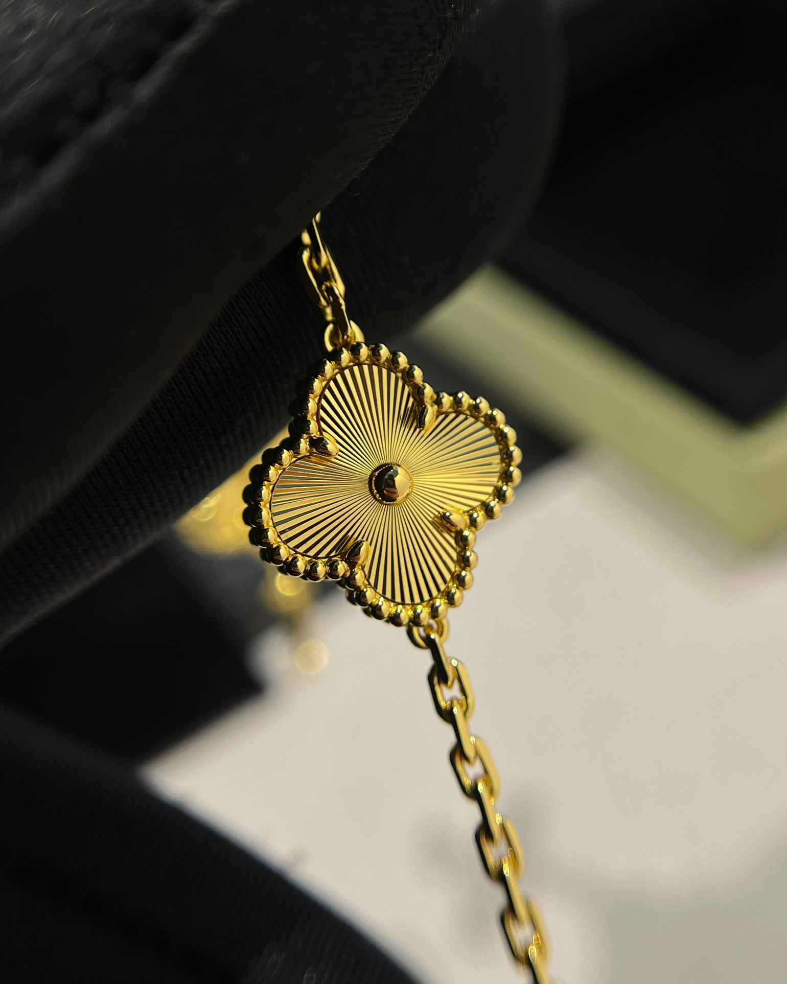 Designer gold bracelet with lucky clover charm for women