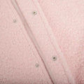 Stylish pink fleece jacket hanging on wooden hanger, soft girl inspired coat with cozy texture
