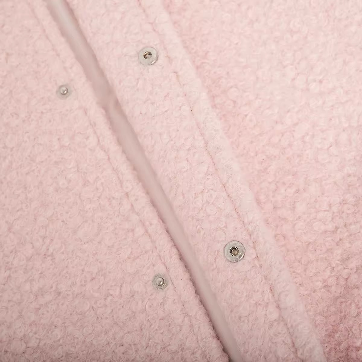 Stylish pink fleece jacket hanging on wooden hanger, soft girl inspired coat with cozy texture
