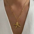 Boho-inspired gold shell necklace with freshwater pearl accents