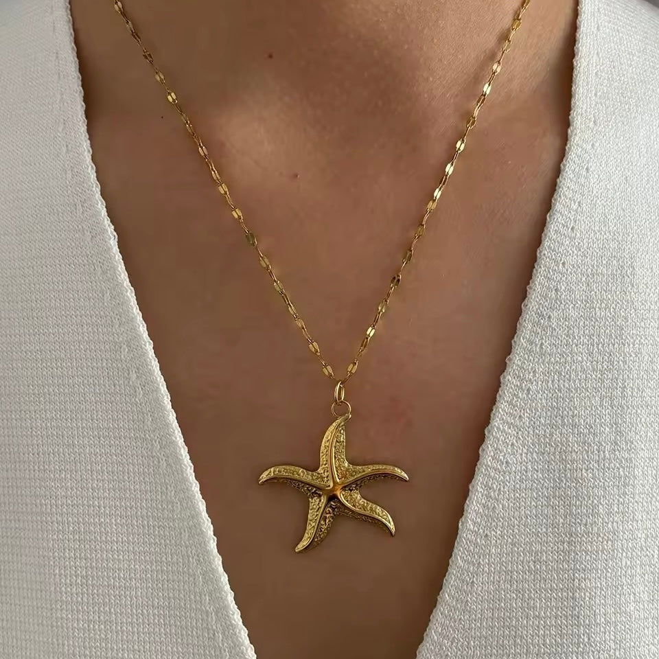 Boho-inspired gold shell necklace with freshwater pearl accents