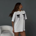 Minimalist bow T-shirt for women with cute print design, featuring Y2K Korean fashion influence and a casual loose-fit cotton short-sleeve style