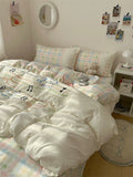 Pastel-colored bedding set with musical notes on a bed in a bedroom.