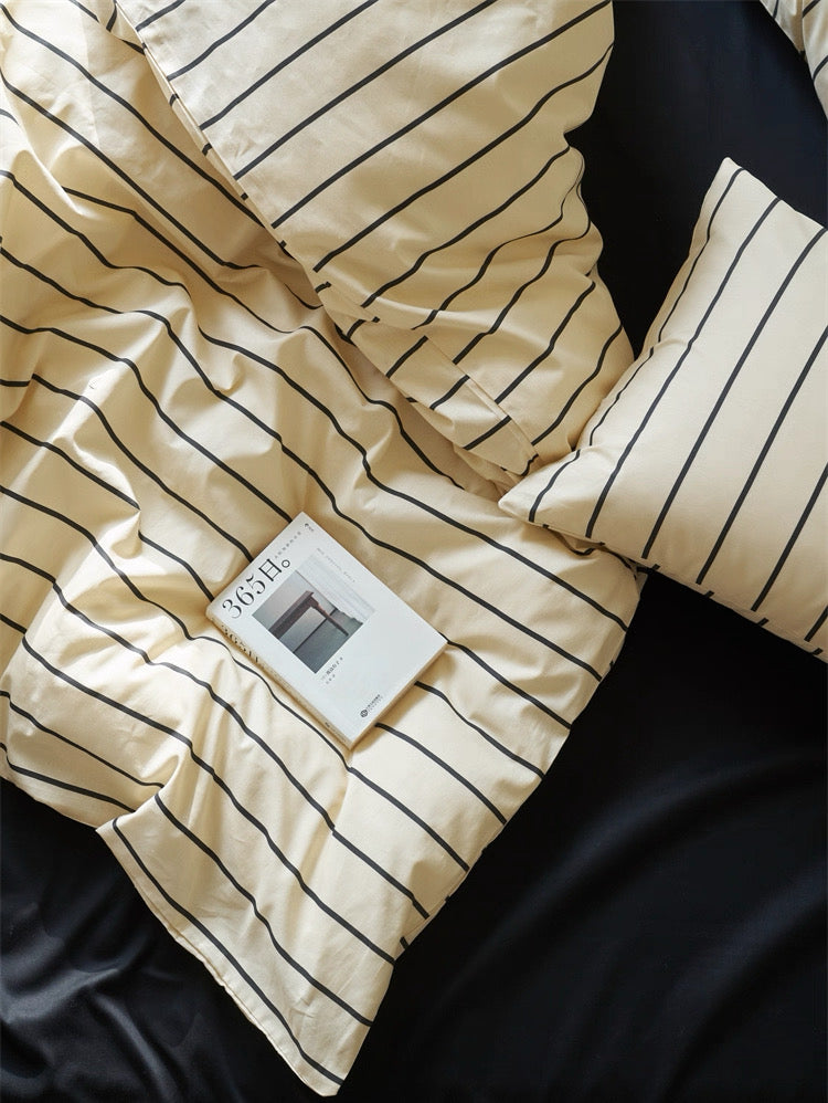 Beige striped blanket with a tag on a dark surface
