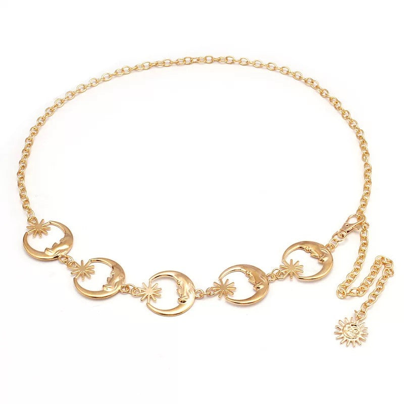 Close-up of moon pendant on aesthetic gold waist chain belt