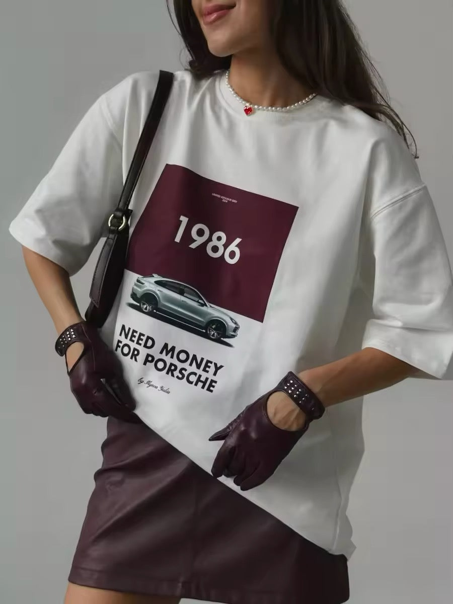 Oversized white Porsche t-shirt with 1986 print on bed