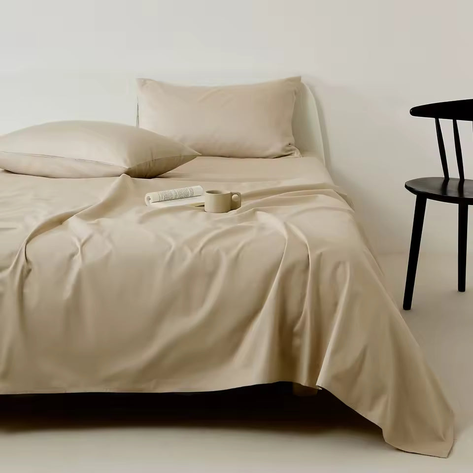 Beige bedding set on a bed with a minimal background