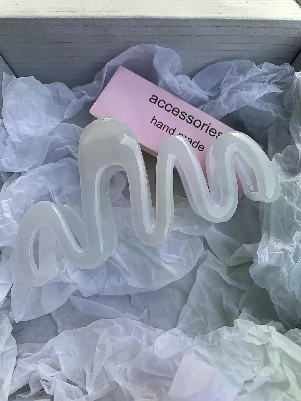 Stylish plastic hair claw with a trendy jelly wave shape