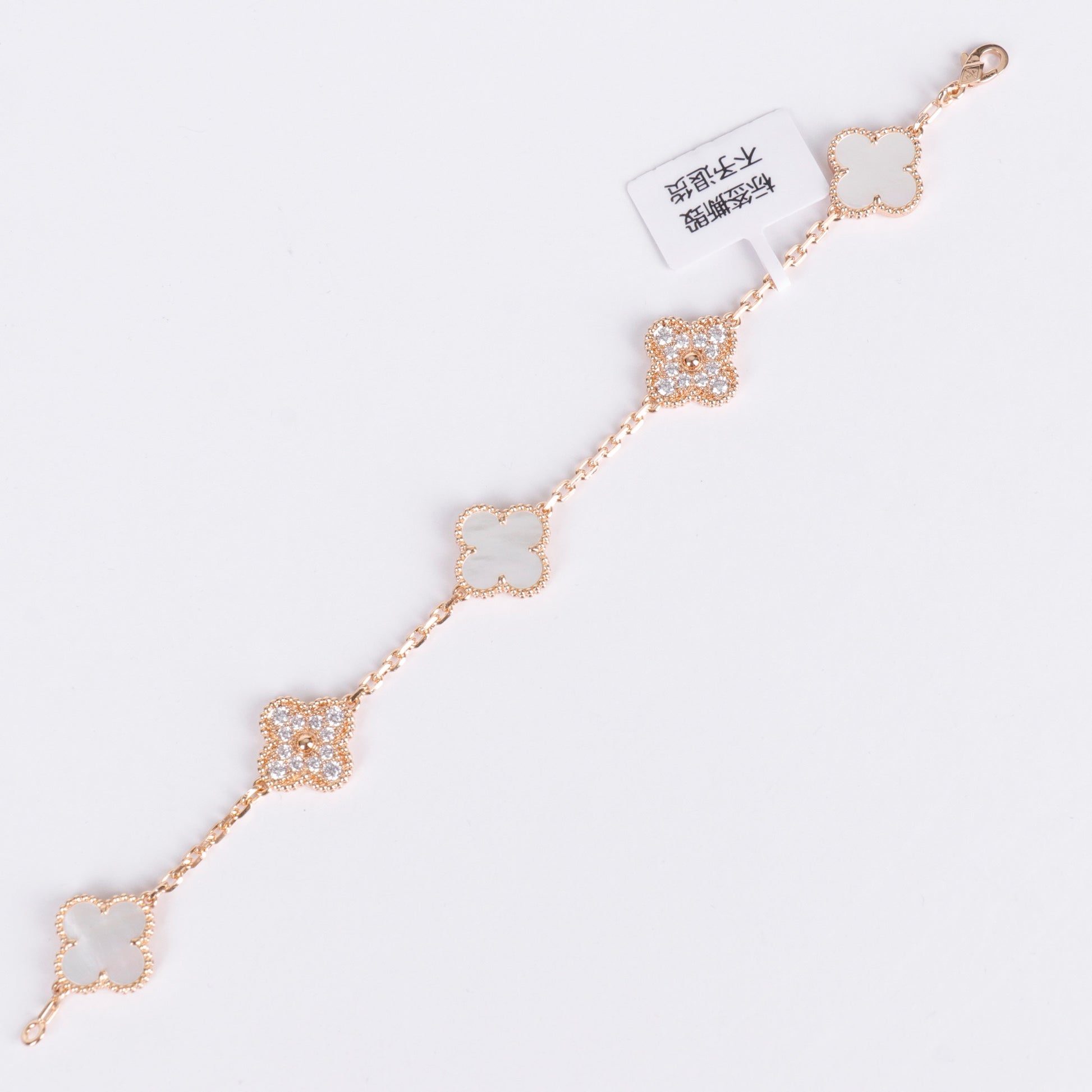 Four-leaf clover bracelet with crystals and pearl enamel accents