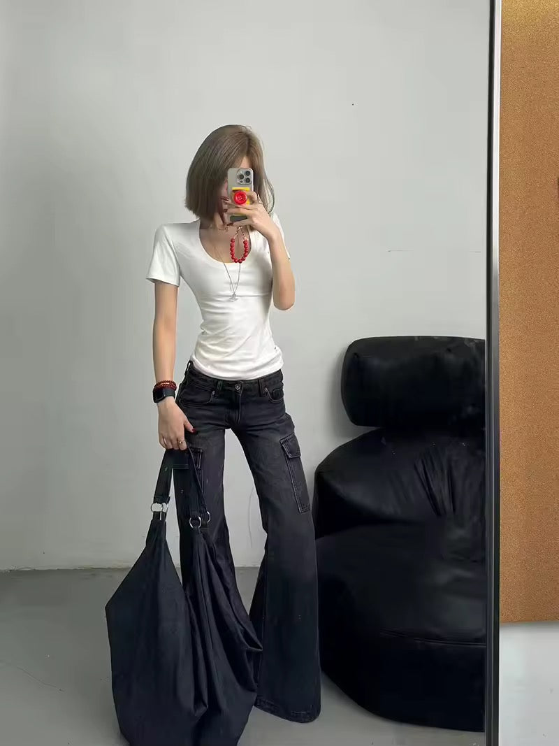 Front view of high-waisted black flared jeans showcasing wide-leg design and multiple pockets.