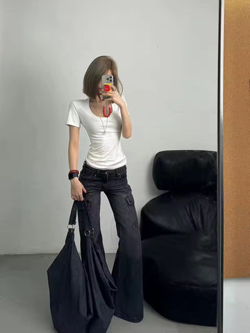 Front view of high-waisted black flared jeans showcasing wide-leg design and multiple pockets.