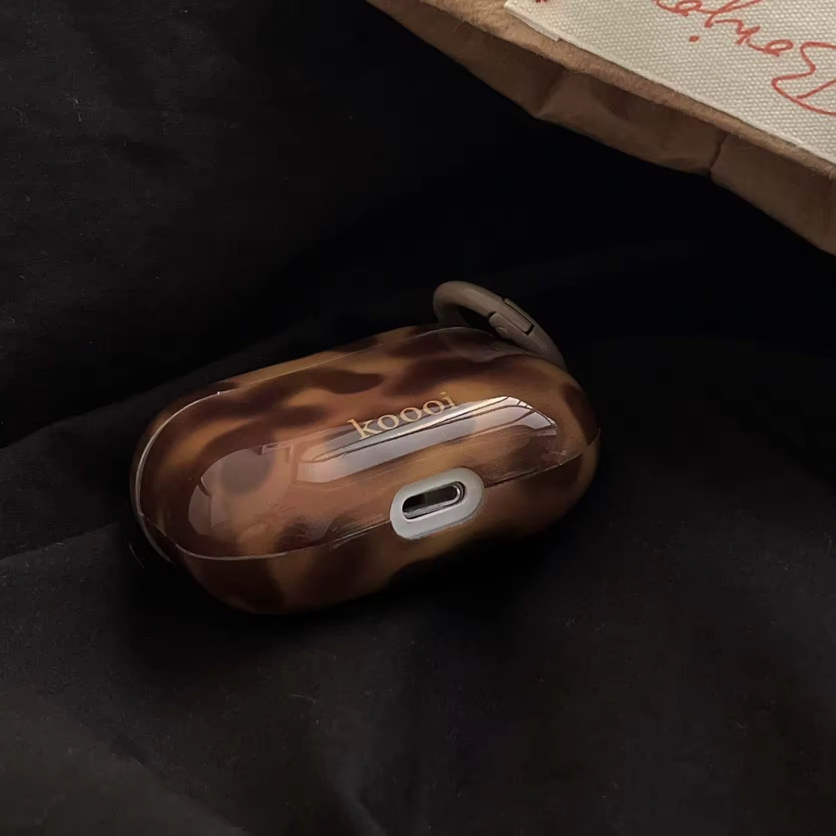 Minimalist amber tech accessory for AirPods