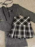 retro coquette outfit with grey v-neck sweater and plaid skirt