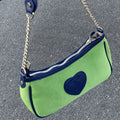 Side angle highlighting the bag's compact size and elegant design.