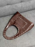 Vintage Maillard tone leather bag styled with motorcycle outfit