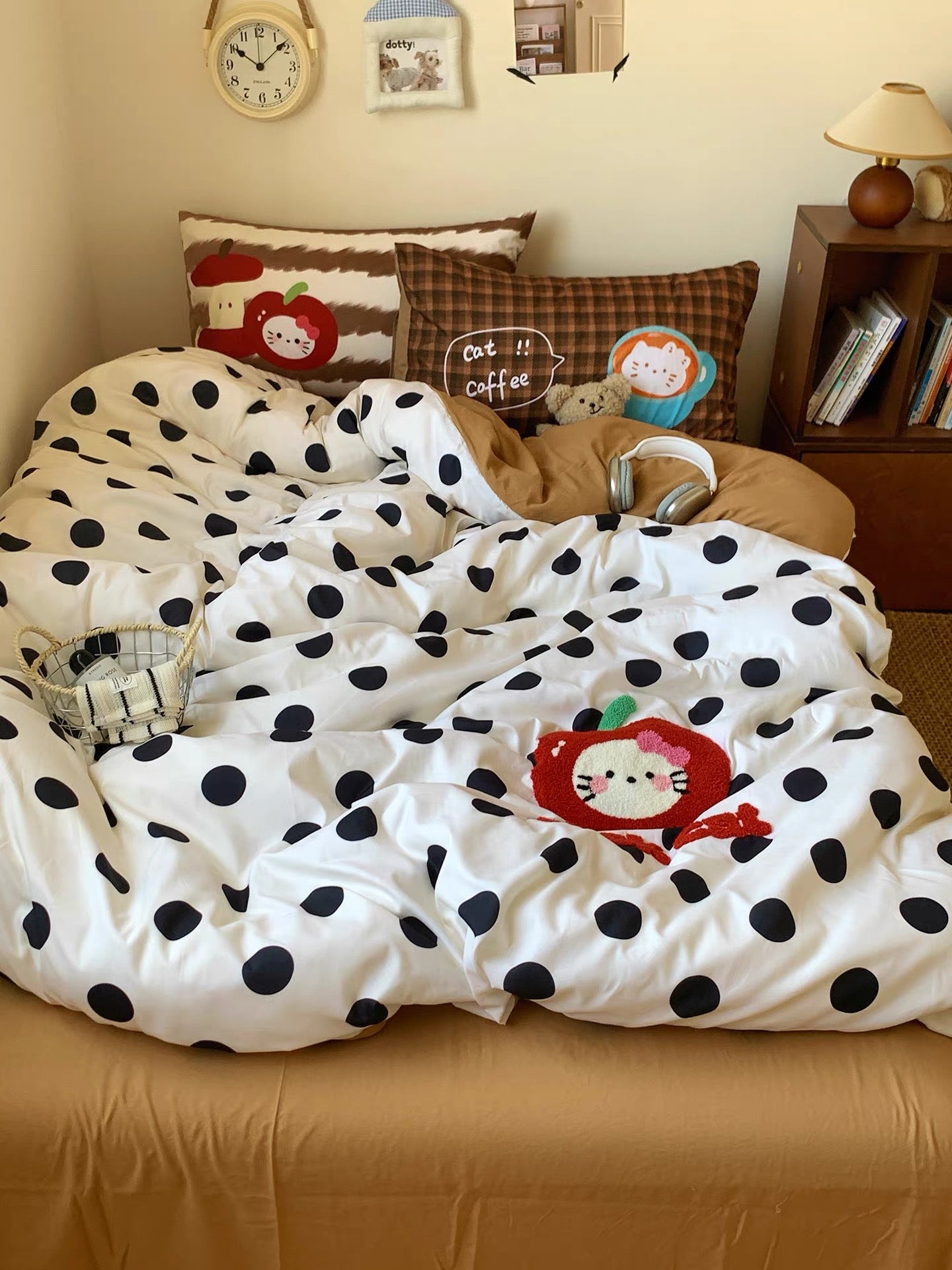 Polka dot comforter with cartoon character on a bed in a bedroom setting