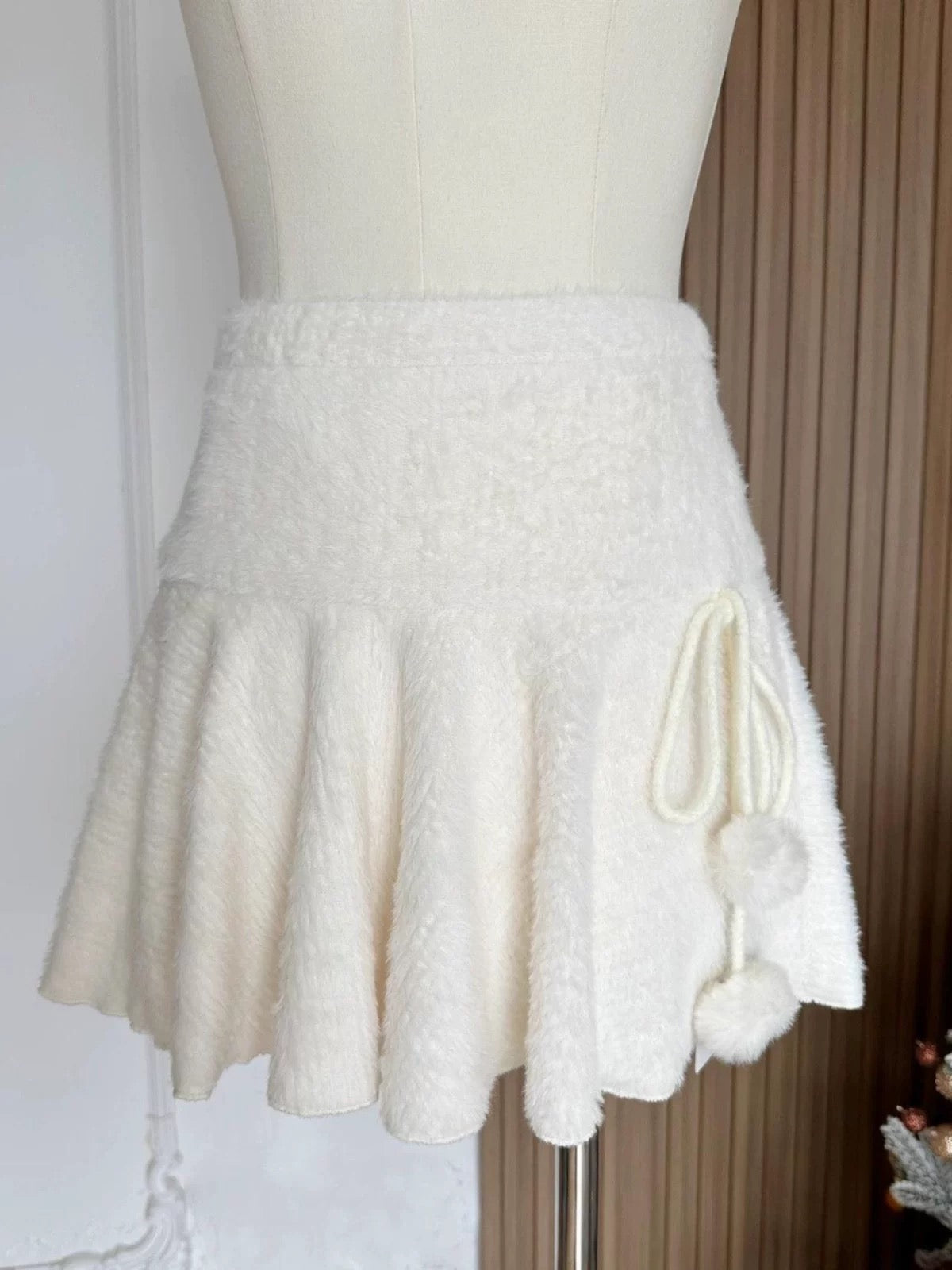 Cozy knit white mini skirt laid flat