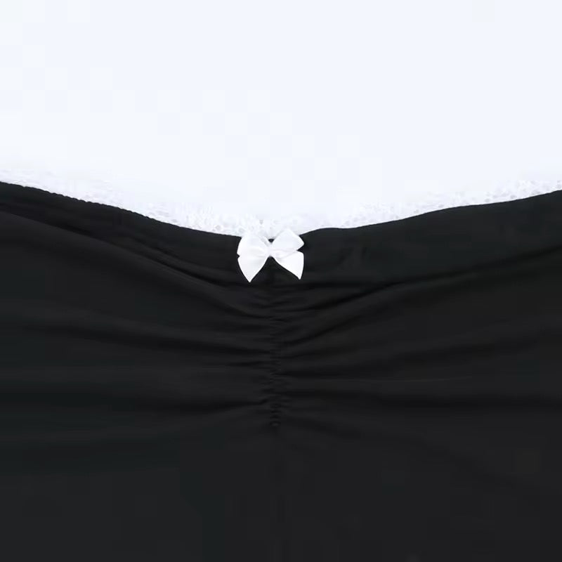Figure-hugging sleeveless crop top with lace detailing and a chic bow