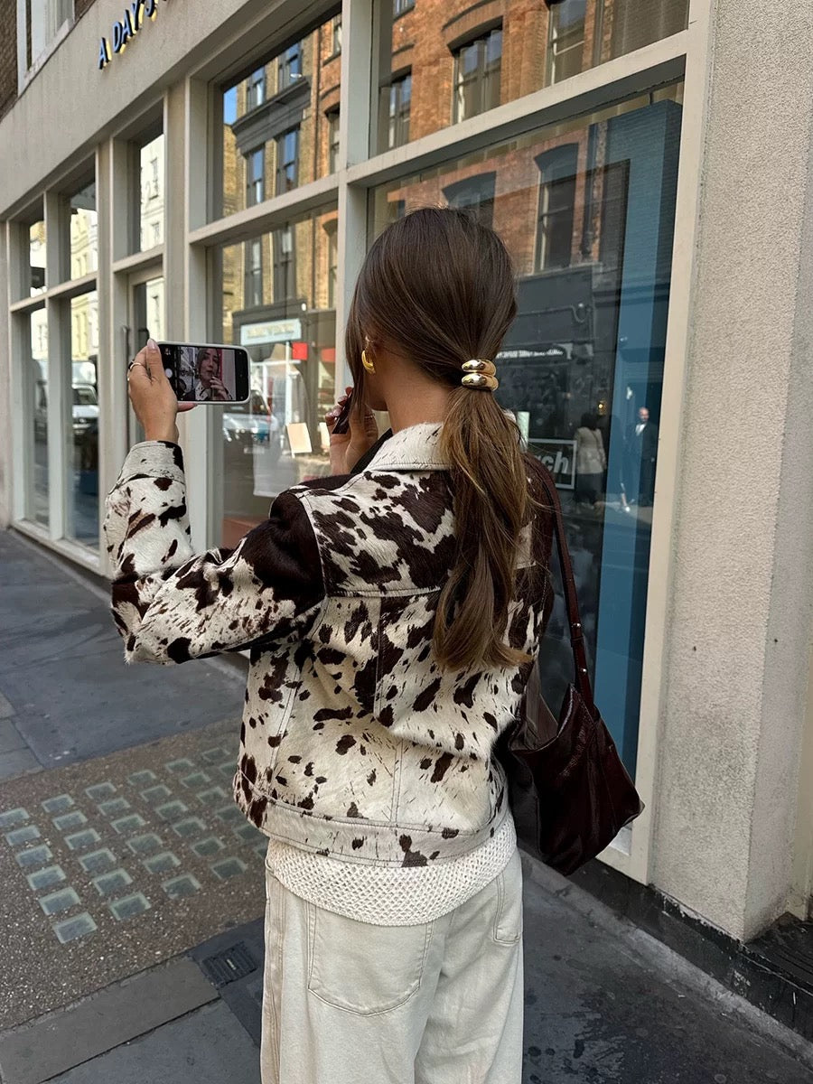 Trendy cow print jacket with soft wool texture, turn-down collar and short cut for modern vintage street style