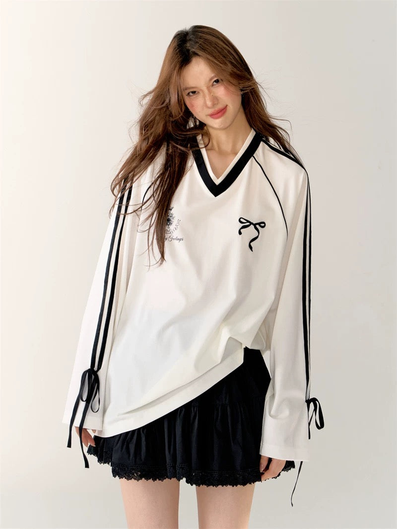 Close-up of V-neck and ribbon tie on sleeve of the white coquette aesthetic top.
