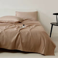Beige bedding set on a bed with a minimal background